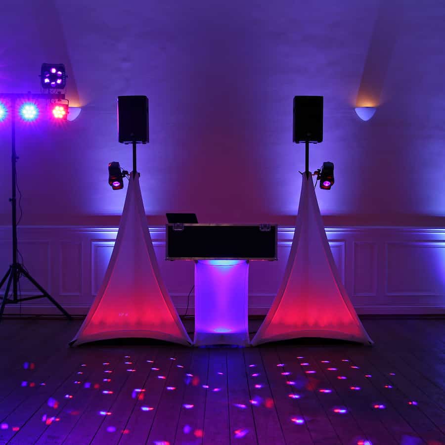 Multi-colored uplights during a DJ set