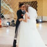 Bride and groom kiss in the middle of an empty dance floor