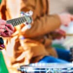 Festival music band. Hands playing on percussion instruments in city park . Drums with sticks closeup.
