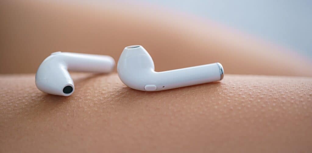 A closeup shot of AirPod headphones on a person's skin with goosebumps.