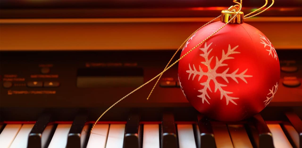 A Christmas ornament sits on a keyboard.